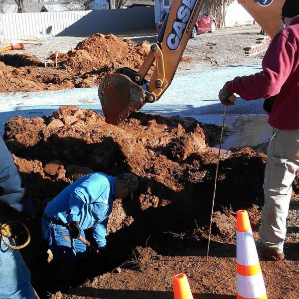 During a directional bore under East Birch Street, our contractors cut into a water line no one knew was there. Workers from the Town of Carnegie work at repairing the line.